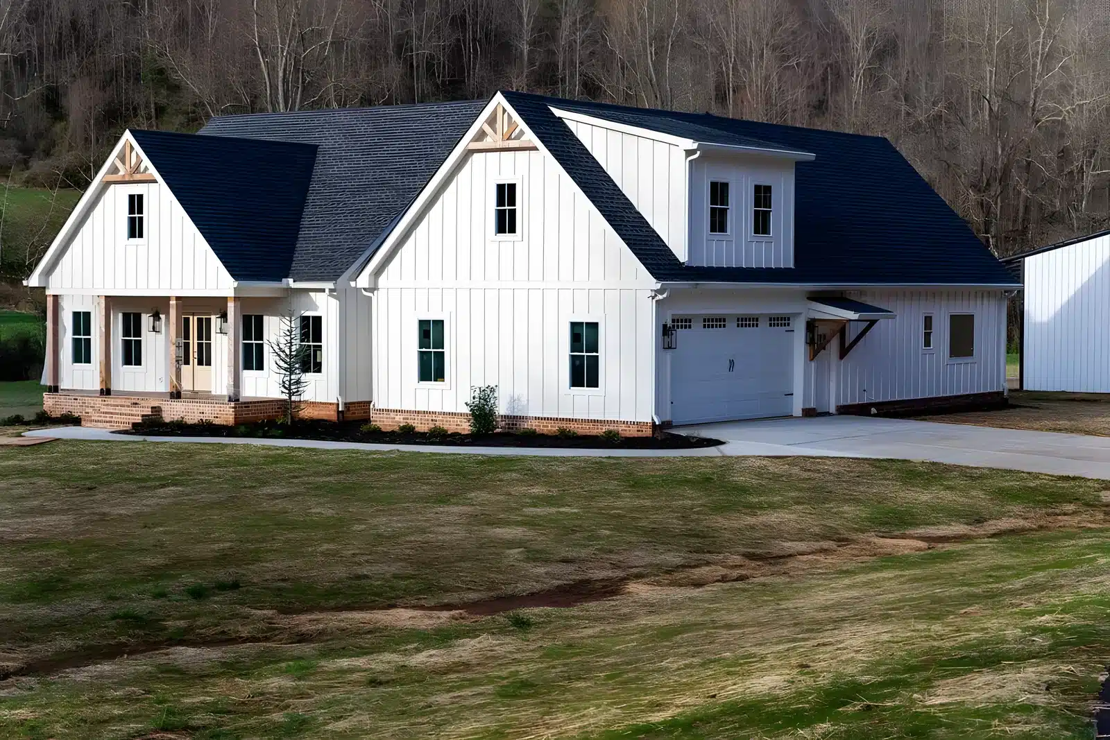 White board-and-batten farmhouse with a covered porch built by Lanier Home Builders